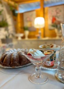 a table with a plate of cake and a glass at B&B Luxury Villa Olimpia in Selva di Fasano