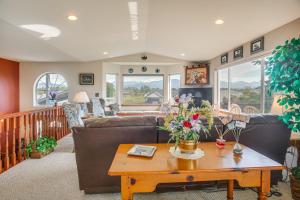 a living room with a couch and a table at Charming Sequim House w/ Olympic Peninsula Views! in Sequim