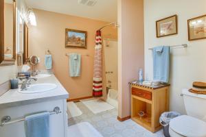a bathroom with a sink and a toilet and a shower at Charming Sequim House w/ Olympic Peninsula Views! in Sequim +16 photos
