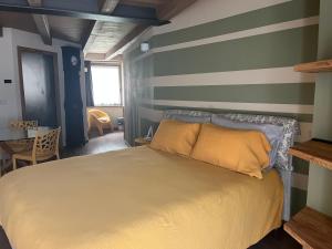 a bedroom with a bed and a striped wall at La Crevasse Morgex in Morgex