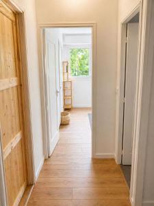 an empty hallway with a door leading into a room at Chambre privative Paris 13e in Paris