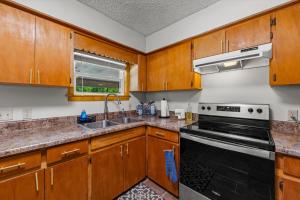 a kitchen with wooden cabinets and a stove top oven at Nantahala Ridge in Bryson City +71 photos