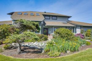 a house with a garden in front of it at Unique Home w/ Beautiful Mtn Views! in Sequim