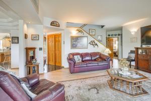 a living room with a couch and a table at Unique Home w/ Beautiful Mtn Views! in Sequim