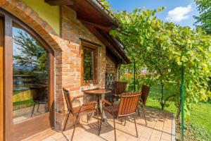a patio with a table and chairs on a brick building at Forge of Happiness Rustic Retreat - Happy Rentals in Gradac