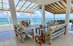 a living room with chairs and a view of the ocean at Hotel Punta Blanca - Jama - Manabí in Jama