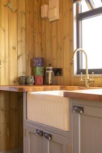 a kitchen counter with a sink and a window at Valentine in Longdown
