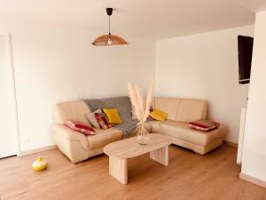 a living room with a couch and a table at Gîte La Chaumière avec Piscine in Nailhac