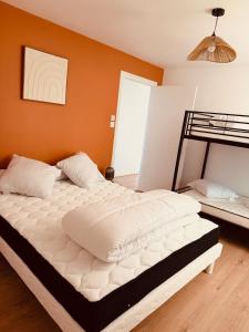 a bedroom with a large bed and a bunk bed at Gîte La Chaumière avec Piscine in Nailhac