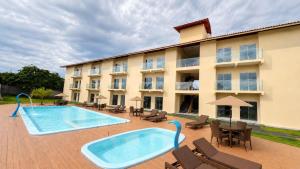 a hotel with a swimming pool and patio furniture at Pousada Brisa dos Lençóis in Barreirinhas +10 photos