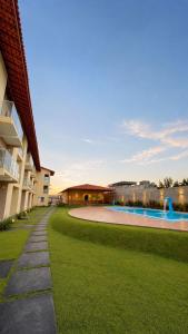 a courtyard with a swimming pool next to a building at Pousada Brisa dos Lençóis in Barreirinhas