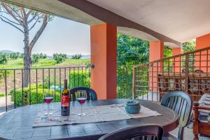 a table with two glasses of wine on a balcony at Capracotta in Montemassi