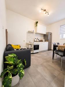 a living room with a couch and a kitchen at Komiža Sea Breeze in Komiža +4 photos