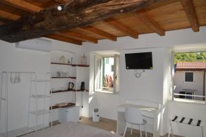 a living room with white walls and wooden ceilings at Affittacamere Ca' Vecia in Riccò del Golfo di Spezia