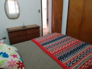 a bedroom with a bed with a colorful blanket on it at Casa de Esther in Salsipuedes +14 photos