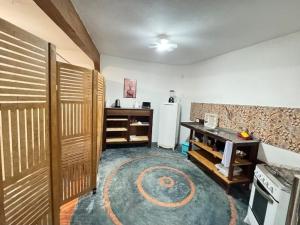 a room with a kitchen with a refrigerator and a table at Pousada Aldeia in Ilha de Boipeba +54 photos