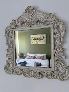 a mirror on a wall with a bed in it at Perle Verte de Gammarth in Tunis +6 photos
