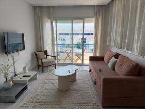 a living room with a couch and a table at Perle Verte de Gammarth in Tunis