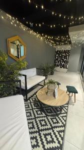 a living room with a table and a couch at Luxury Towers Arequipa in Arequipa