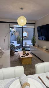 a living room with a couch and a table at Luxury Towers Arequipa in Arequipa