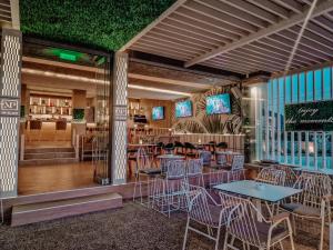 a restaurant with tables and chairs and a bar at My Place modern living in Kefalos
