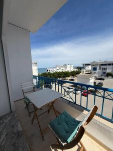 a table and chairs on a balcony with a view of the ocean at Perle Verte de Gammarth in Tunis