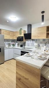a kitchen with a counter with plates and glasses on it at Luxury Towers Arequipa in Arequipa