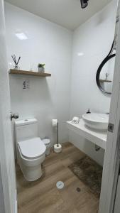 a white bathroom with a toilet and a sink at Luxury Towers Arequipa in Arequipa +31 photos