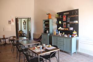 a dining room with tables and chairs and a counter at B&B del Borgo in Ortezzano +24 photos