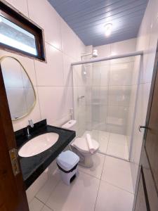 a bathroom with a sink and a toilet and a shower at Pousada Brisa dos Lençóis in Barreirinhas