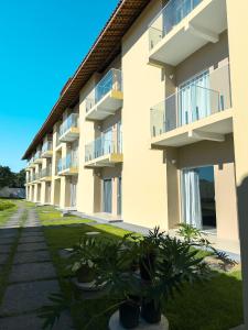 a row of apartment buildings with potted plants at Pousada Brisa dos Lençóis in Barreirinhas