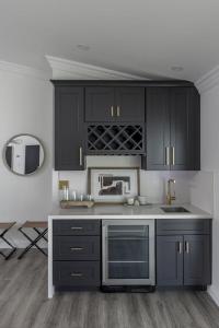 a kitchen with black cabinets and a sink and a mirror at Old Town Fashion(ed)-Pool-Putting Green-BBQ Grill in Scottsdale