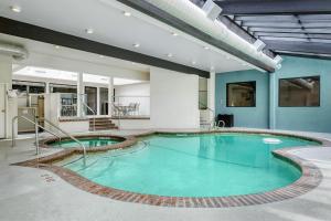a large pool in a building with blue walls at Best Western Seattle Airport Hotel in SeaTac