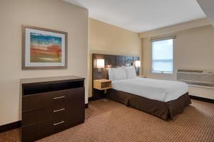 a hotel room with a large bed and a dresser at Best Western Seattle Airport Hotel in SeaTac +57 photos