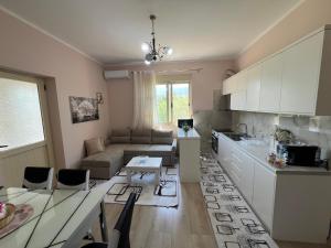a kitchen and living room with a couch and a table at Nesti house in Orikum