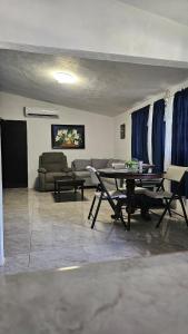 a living room with a table and a couch at Villa Privada 1200m2 Laguna a Pasos Pet Friendly in Xul-Ha