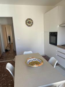 a table in a kitchen with a plate on it at Gemma's Apartments in Mazzeo +2 photos