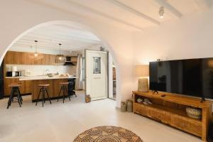a living room with a large flat screen tv at 5 SENSES in Pefki