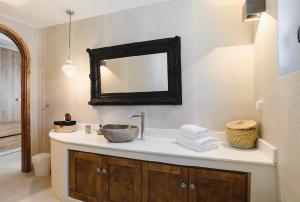 a bathroom with a sink and a mirror at 5 SENSES in Pefki +8 photos