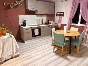 a kitchen with a wooden table and a table and chairs at Apartment Ivana in Murter