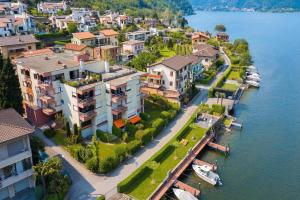 an aerial view of a town next to the water at Casa Bader - Lake View Apt with Pool & Sauna - Happy Rentals in Riva San Vitale