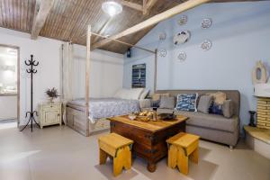 a living room with a couch and a bed at Yianna Cottage Studios in Skopelos Town