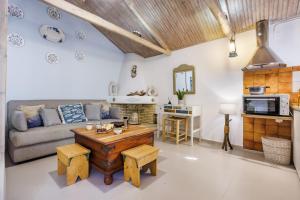 a living room with a couch and a table at Yianna Cottage Studios in Skopelos Town