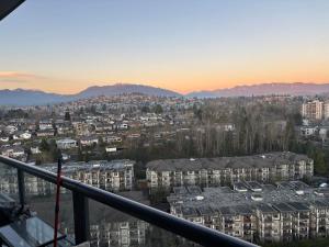 a view of a city at sunset from a balcony at Brentwood Retreat in Burnaby