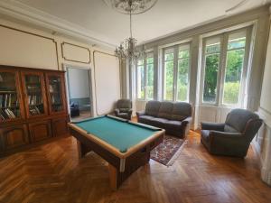 a living room with a pool table and chairs at Manoir, vaste parc arboré in Montbron
