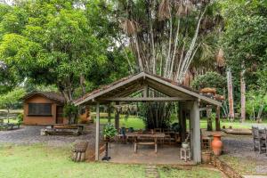 a pavilion in a park with a table and benches at Jardim da Amazônia Lodge in Sao Jose do Rio Claro