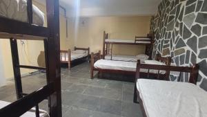 a room with three bunk beds in a room at Pousada Cantinho e Sossego casa 5 in Vespasiano