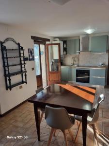 a kitchen with a wooden table and chairs in it at Casale Montanari in Matigge