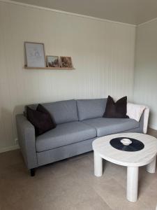 a living room with a couch and a coffee table at Leilighet midt i sentrum in Kirkenes +1 photo