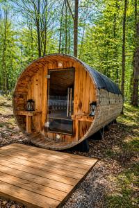 a large wooden building in the middle of a forest at The Aurora Inn & Cottages in Bartlett